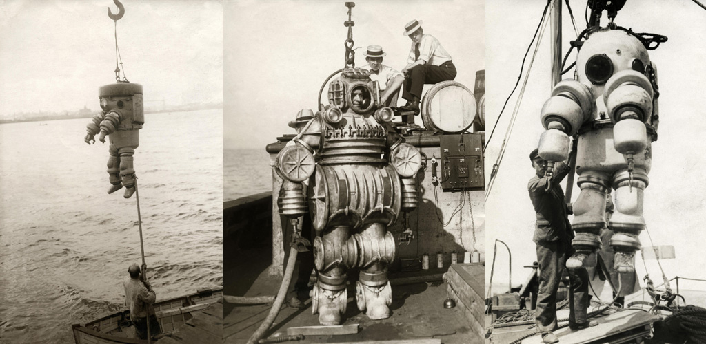 Diver in metal diving suit attached to cable