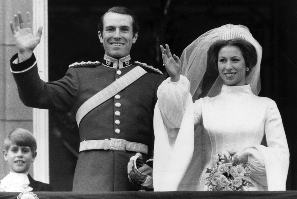 Princess Anne, the Princess Royal seen smiling and waving from the balcony of Buckingham Palace following her marriage to Captain Mark Phillips at Westminster Abbey on 14 November 1973. Prince Edward, now the Duke of Wessex, who served as a pageboy can be seen beside the couple. Date: 1973