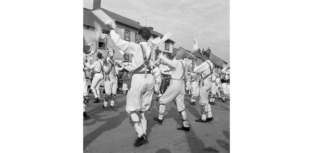 A group of morris men performing a handkerchief dance in Town Street Date: 1948 - 1952