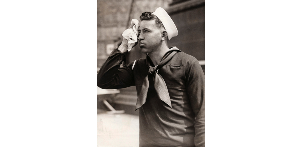 A young sailor on a hot day in London, wiping his face with a handkerchief. Date: 15 June 1934