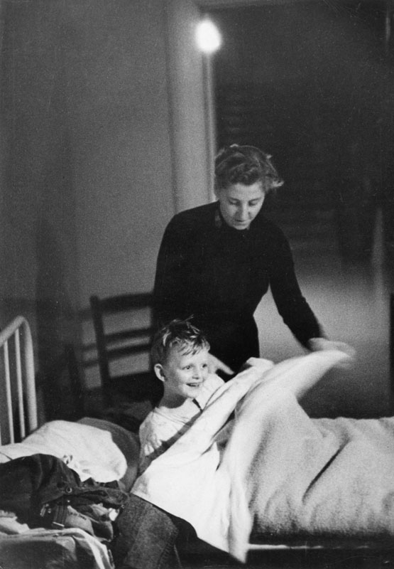A little boy being put to bed with the help of staff at the Strawberry Fields orphanage in Liverpool.
circa 1950