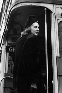 A woman in a stylish coat and turban style hat climbing aboard the no. 7 Routemaster London bus which is destined for Holborn by the looks of things. Date: 1940s