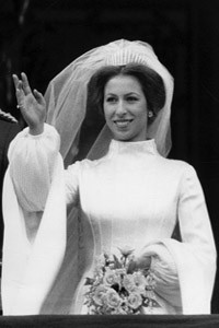 Princess Anne, the Princess Royal seen smiling and waving from the balcony of Buckingham Palace following her marriage to Captain Mark Phillips at Westminster Abbey on 14 November 1973. Prince Edward, now the Duke of Wessex, who served as a pageboy can be seen beside the couple. Date: 1973