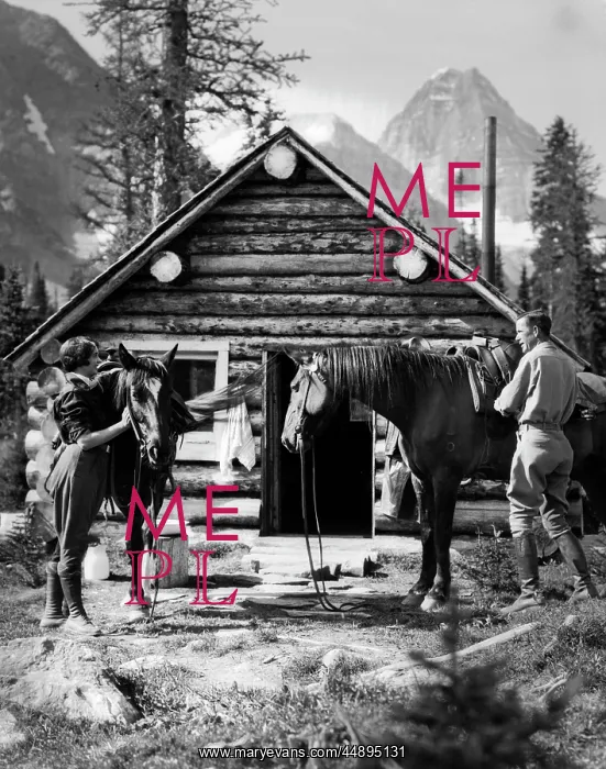 : 1920s 1930s COUPLE IN FRONT OF LOG CABIN STANDING : 1920s 1930s COUPLE IN FRONT OF LOG CABIN STANDING