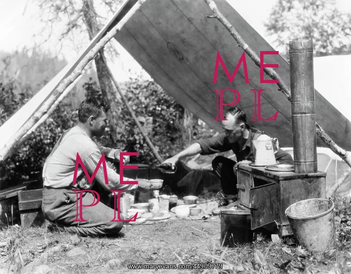 : 1920s two men eating under a frame tent canvas : 1920s two men eating under a frame tent canvas