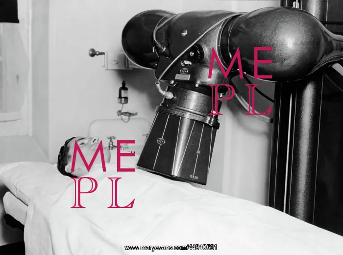 : 1930s 1940s man patient undergoing xray machine : 1930s 1940s man patient undergoing xray machine