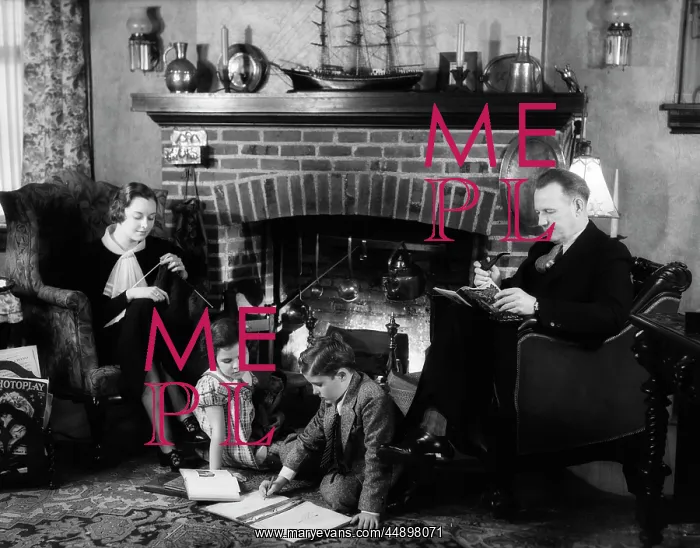 : 1930s FAMILY OF FOUR SITTING IN FRONT FIREPLACE : 1930s FAMILY OF FOUR SITTING IN FRONT FIREPLACE