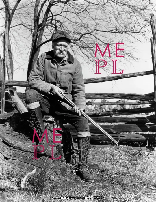 : 1940s elderly man sitting on wood split rail : 1940s elderly man sitting on wood split rail