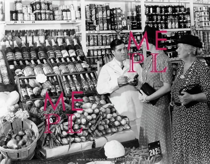 : 1940s Grocer In White Coat Holding : 1940s Grocer In White Coat Holding