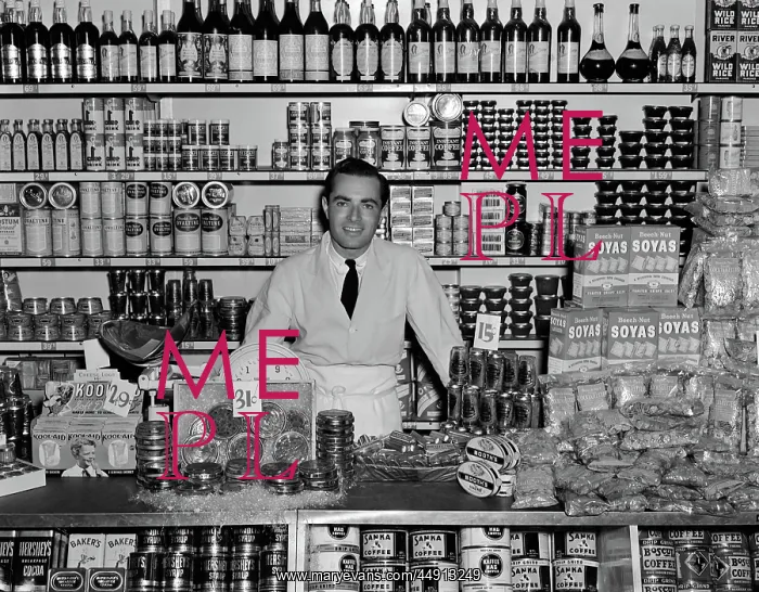 : 1940s SMILING MAN GROCER STANDING BEHIND COUNTER : 1940s SMILING MAN GROCER STANDING BEHIND COUNTER