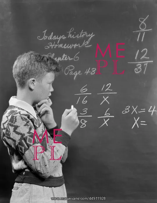 : 1950s BOY AT BLACKBOARD DOING MATH MULTIPLICATION : 1950s BOY AT BLACKBOARD DOING MATH MULTIPLICATION