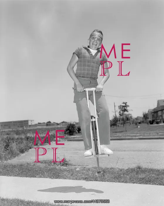  : 1950s Boy Jumping On Pogo Stick