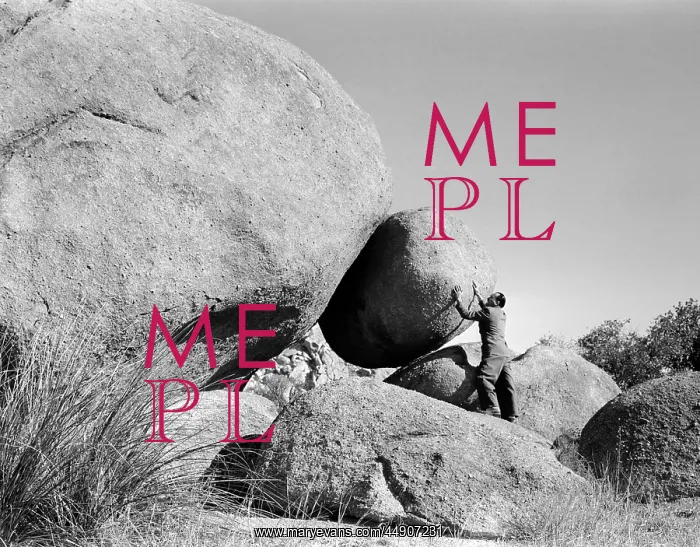 : 1950s symbolic man outdoors holding back large : 1950s symbolic man outdoors holding back large