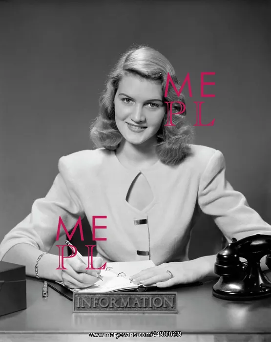  : 1950s Woman Sitting At Information