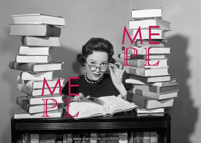 : 1950s woman sitting between stacks of books pulling : 1950s woman sitting between stacks of books pulling