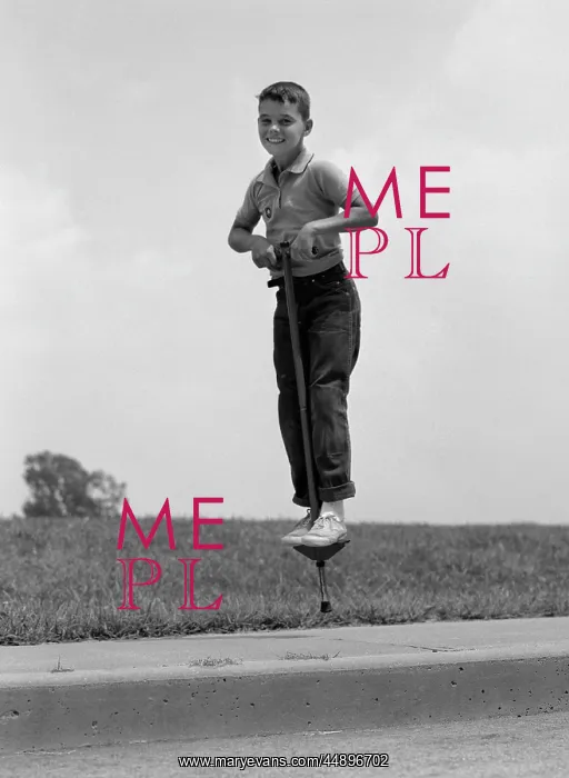  : 1960s Boy Jumping On Pogo Stick