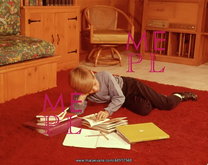: 1960s Boy Reading Studying Homework Lying on Red Shag Car : 1960s Boy Reading Studying Homework Lying on Red Shag Car