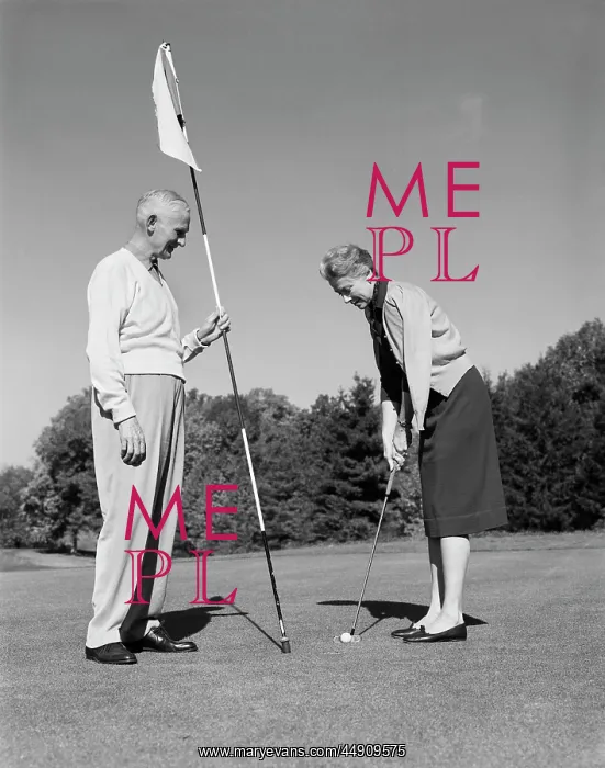 : 1960s elderly woman getting ready to putt while : 1960s elderly woman getting ready to putt while