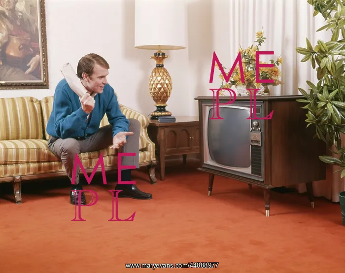 : 1960s Man Sitting On Sofa Holding : 1960s Man Sitting On Sofa Holding