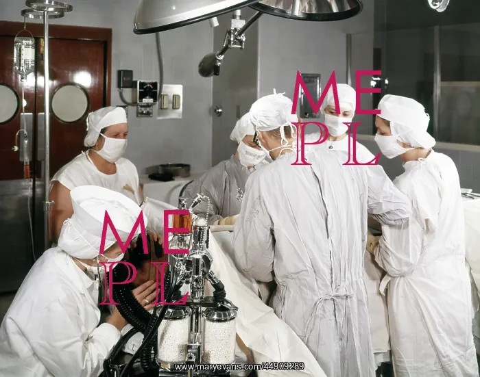 : 1960s operating room team with scrub and circulating : 1960s operating room team with scrub and circulating