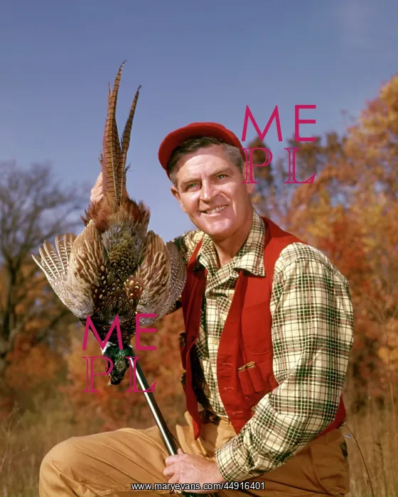 : 1960s Smiling Man Hunter looking at Camera Holding up Har : 1960s Smiling Man Hunter looking at Camera Holding up Har