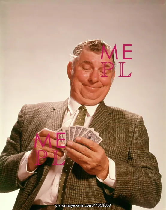: 1960s SMILING SATISFIED MAN LOOKING AT HAND OF : 1960s SMILING SATISFIED MAN LOOKING AT HAND OF
