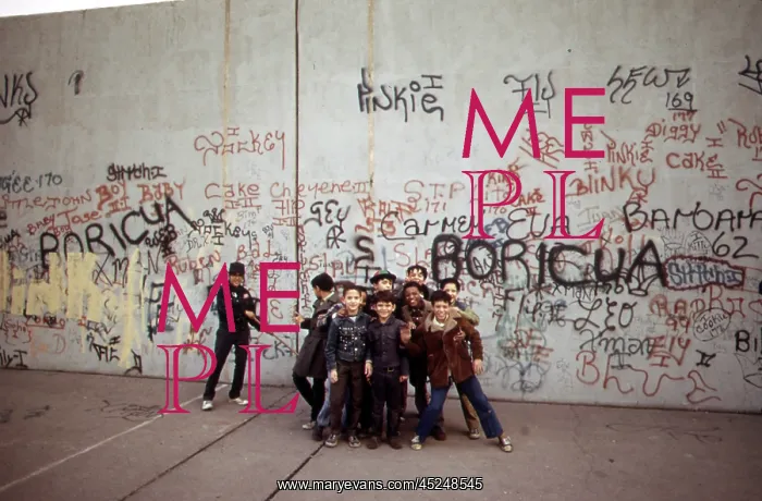 : 1970s America. Young boys pose in front of a graffitied : 1970s America. Young boys pose in front of a graffitied