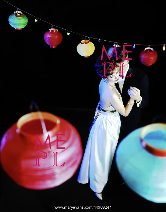 : 1970s Couple In Formal Clothes Dancing Under Colored Paper C : 1970s Couple In Formal Clothes Dancing Under Colored Paper C