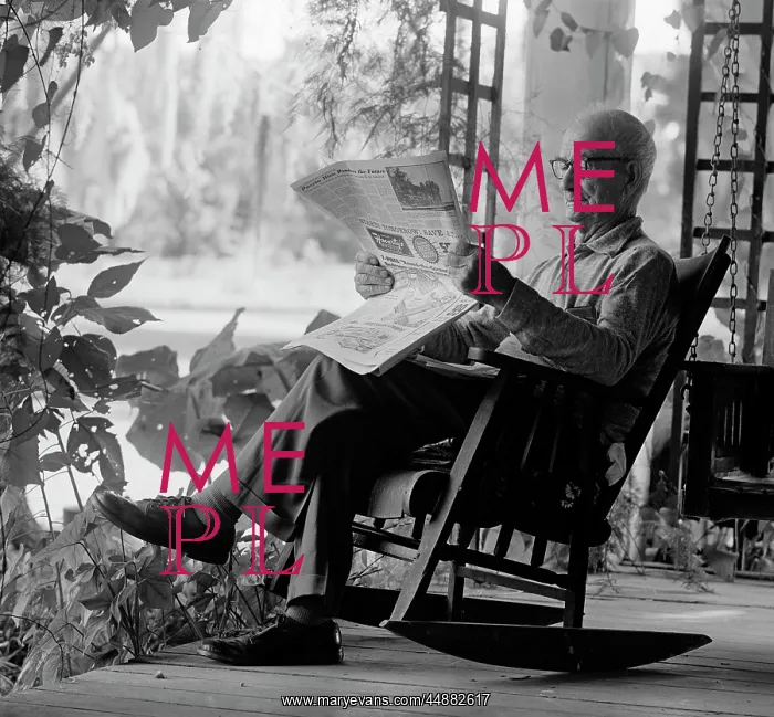 : 1970s Elderly man In rocking chair reading : 1970s Elderly man In rocking chair reading