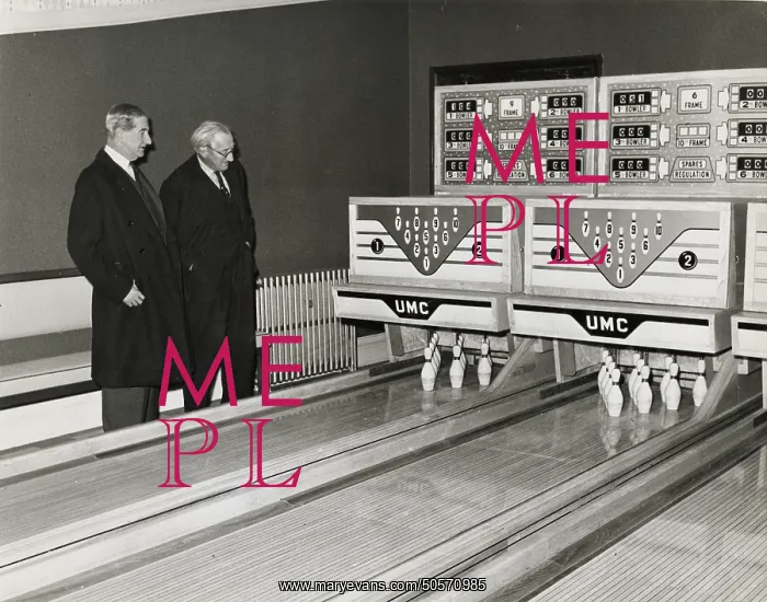 : A. P. Herbert, examining a modern skittles game with automatic scoring system : A. P. Herbert, examining a modern skittles game with automatic scoring system