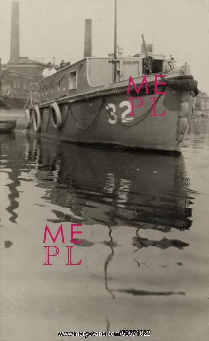 : A. P. Herbert steering a riverboat : A. P. Herbert steering a riverboat