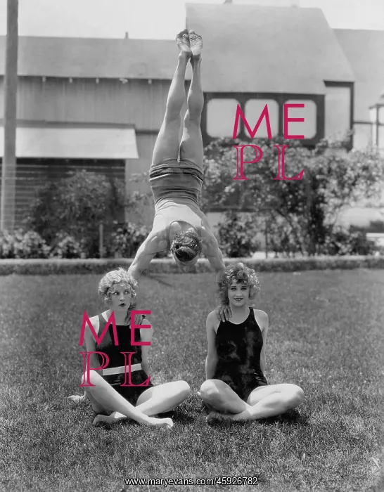 : Acrobat balancing on women's shoulders : Acrobat balancing on women's shoulders