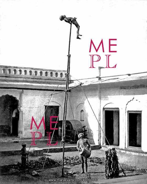 : Acrobat on a pole, with drummer below, India : Acrobat on a pole, with drummer below, India