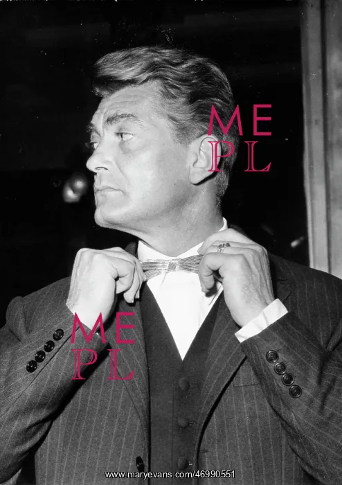 : Actor Jean Marais fixing his bowtie : Actor Jean Marais fixing his bowtie