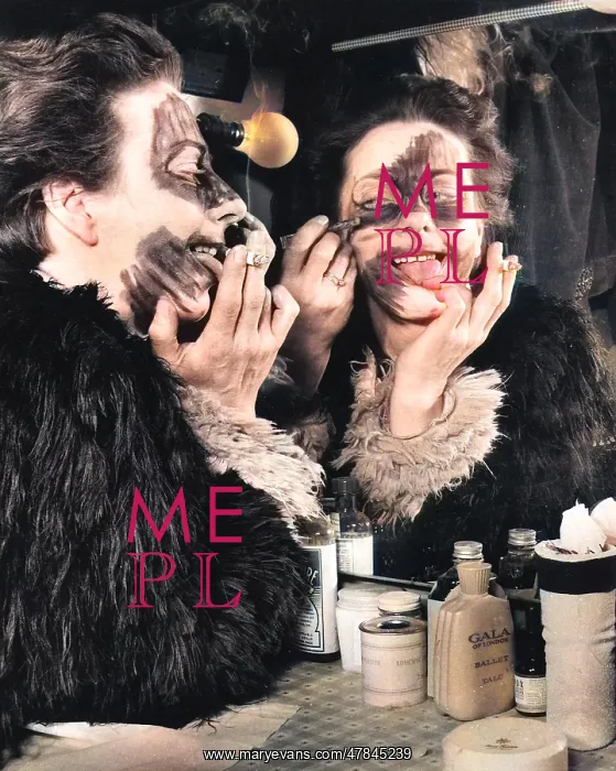: Actress Freda Wyn doing cat makeup for a pantomime : Actress Freda Wyn doing cat makeup for a pantomime