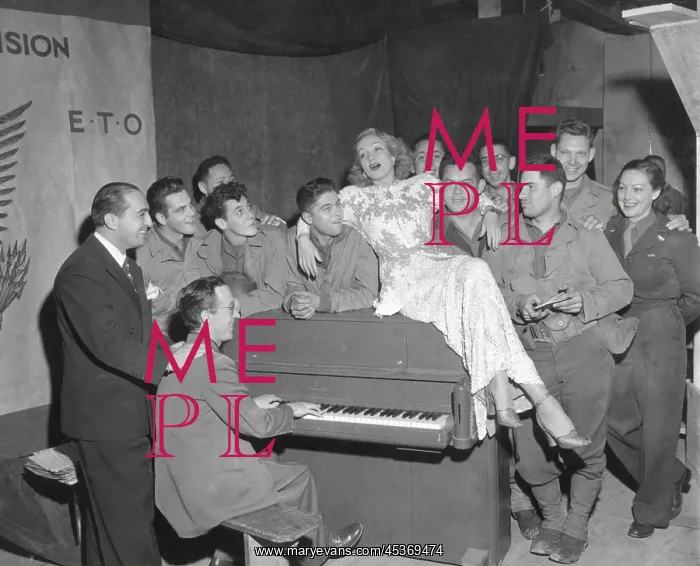 : Actress Marlene Dietrich singing for a group of : Actress Marlene Dietrich singing for a group of