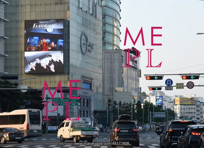 : Advert for K-Pop boyband IKON above a busy intersection : Advert for K-Pop boyband IKON above a busy intersection