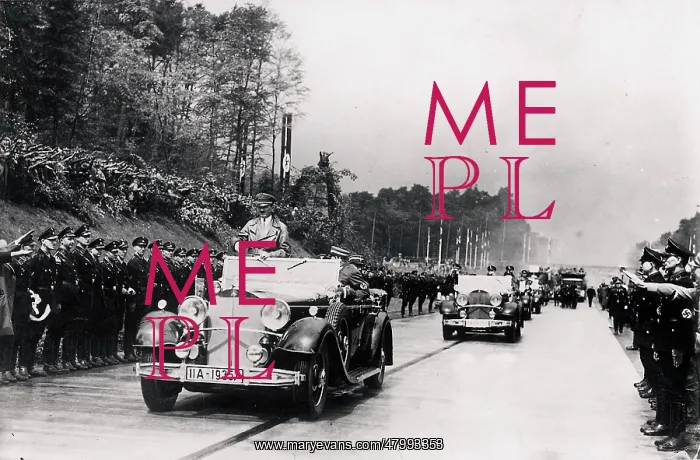 : Adolf Hitler passes, standing in his car on May 19 : Adolf Hitler passes, standing in his car on May 19