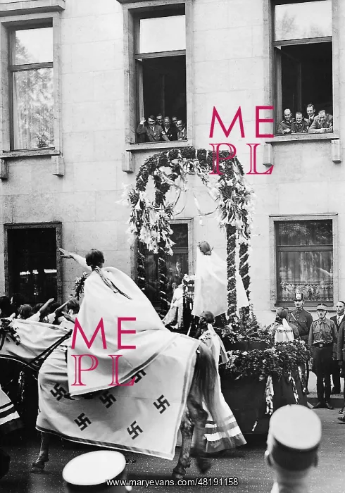 : Adolf Hitler at the window during a pageant for the First of : Adolf Hitler at the window during a pageant for the First of
