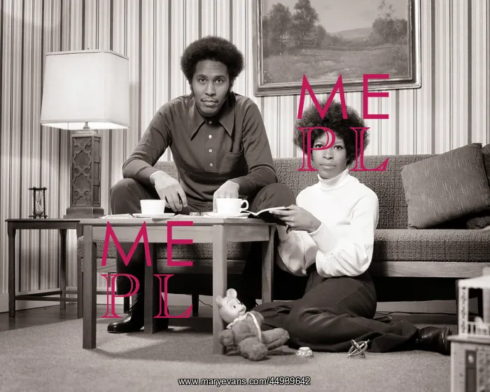 : African-American Couple at Coffee Table Looking : African-American Couple at Coffee Table Looking