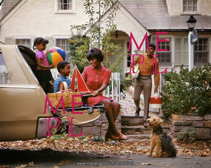 : African American Family of Four Loading Car For : African American Family of Four Loading Car For