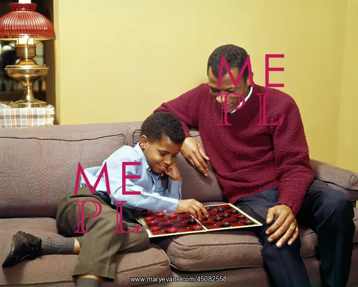 : African American Father and Son Sitting on Couch : African American Father and Son Sitting on Couch