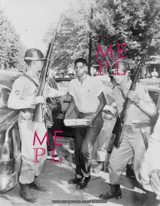 : An African American student is escorted ? : An African American student is escorted ?
