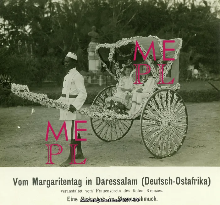 : An African man pulls a rickshaw with three white children : An African man pulls a rickshaw with three white children