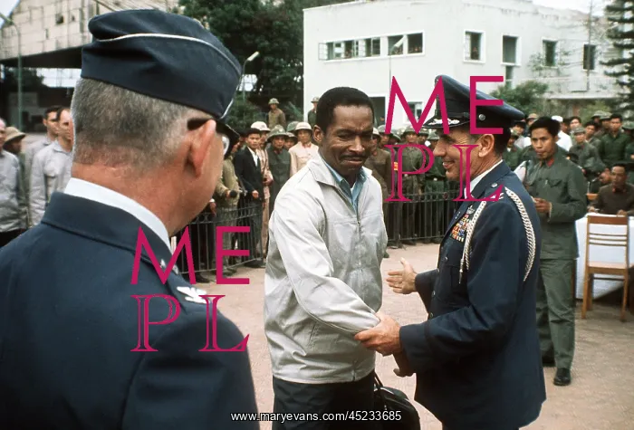 : Air Force Major Norman A. McDaniel is greeted ? : Air Force Major Norman A. McDaniel is greeted ?