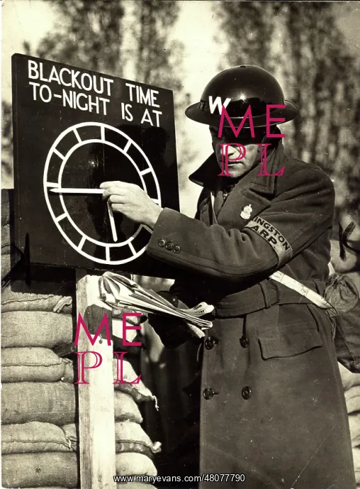 : An Air Raid Warden adjusts the Blackout Time indicator : An Air Raid Warden adjusts the Blackout Time indicator