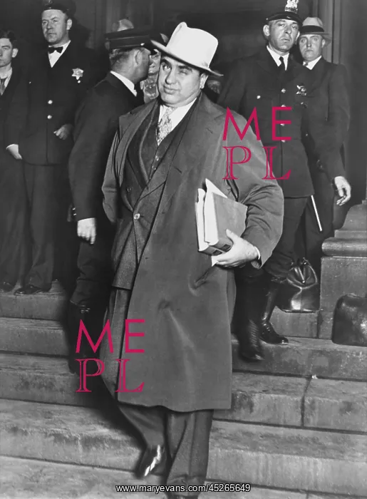 : Al Capone, winks at photographers as he leaves : Al Capone, winks at photographers as he leaves