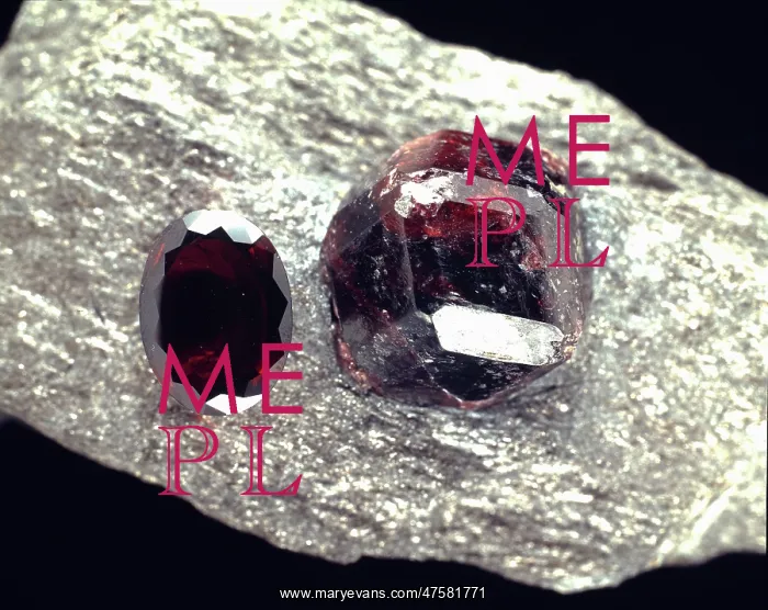 : Almandite. A crystal and a cut stone of almandite, a deep red garnet comprised of : Almandite. A crystal and a cut stone of almandite, a deep red garnet comprised of