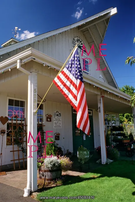 : American Flag Hanging in Front of Convenience Store : American Flag Hanging in Front of Convenience Store