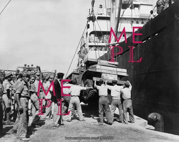 : American-made truck lowered from a freighter at : American-made truck lowered from a freighter at